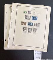 Photo showing 3 cream-colored single-sided stamp pages with Belgium stamps affixed, including portraits and air mail stamps.