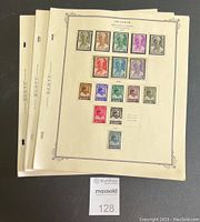 Stack of Scott stamp album pages, showing multiple colorful Belgium stamps affixed in rows with clear denominations.