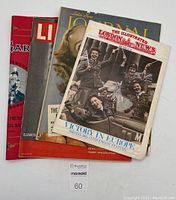Photo showing the four large vintage magazines stacked with visible covers: The Illustrated London News, Ladies Home Journal, Life, and Royal Garland.