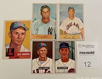 Photo of all five baseball cards laid out together showing front sides with player portraits and names.