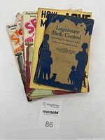Top view of the six vintage booklets stacked, showing covers including Legitimate Birth Control (blue cover) and colorful Sexology issues.