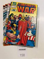 Six Infinity War comic books arranged on a white surface, showing colorful covers with Marvel superheroes, label indicating lot 158.