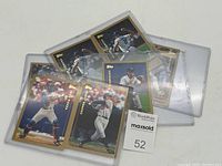 Eight vintage Topps baseball cards in clear plexi protectors, laid out with player images visible on the front sides.