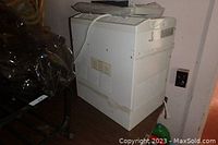 Photo of the Danby air conditioner placed on the floor near a wall with power outlet visible.