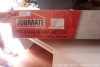 Box label showing Jobmate brand and folding work bench description and dimensions.