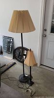 Both lamps shown together, floor lamp notably taller with damaged pleated shade, table lamp smaller with decorative details.