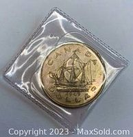 Front side of the 1949 Canadian Silver Dollar showing the sailboat and inscriptions.