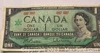 Front side of the 1967 Canadian one dollar bill showing Queen Elizabeth II portrait and bilingual denomination text.