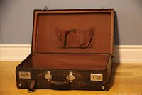 Open interior view showing brown fabric lining and internal pocket with snap closure