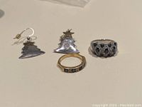 All three jewelry pieces on flat surface