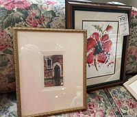 Two framed watercolour paintings, one architectural piece and one floral motif, both with glass and matte.
