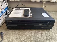 Front view of Pioneer CLD-S105 player showing disc tray, control dial, and front panel branding.