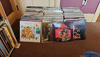 Front view of multiple Laserdisc sleeves standing on floor; shows assorted titles