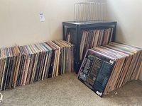Overall collection of loose LaserDiscs on floor and shelf