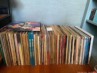 Shelf holding a large collection of LaserDiscs in cardboard sleeves