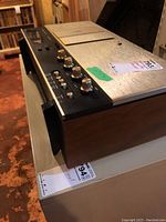 Side angle showing wood veneer side panel, aluminum top and control edge
