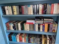 Three shelves of opera CD sets in jewel cases and boxed sets