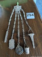 Full view of chatelaine with clip, five chains and attachments