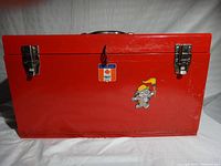 Front view of red metal toolbox closed showing Mastercraft label and mouse sticker.