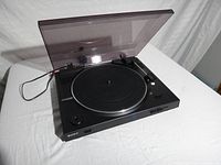 Sony PS-LX300USB turntable with dust cover open, showing platter, tonearm, and control buttons.