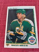 Front side of a 1990/1991 Upper Deck Mike Modano hockey card in Minnesota North Stars uniform, showing player's image, name, position, and rookie team emblem.