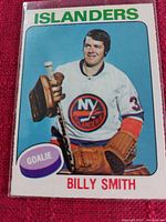 Hockey card of Billy Smith in New York Islanders gear with blue background