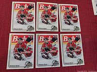Six identical Upper Deck hockey cards featuring Dominik Hasek in goalie gear, laid out in two rows of three on a red surface.