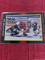Close-up photo of Ed Belfour Chicago Blackhawks hockey card showing player in goalie action and card details.