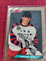 Photo of a vintage Jaromir Jagr NHL hockey card in protective sleeve showing player in practice jersey.