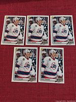5 identical Keith Tkachuk Upper Deck Rookie Report hockey cards laid out on a red cloth surface.