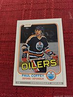 Photo of the front of an O-Pee-Chee hockey card featuring Paul Coffey in an Edmonton Oilers uniform with card number 14 from the Anniversary Series.
