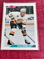Pavel Bure hockey card featuring player in Vancouver Canucks jersey number 10 on ice.