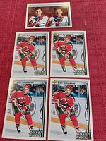 Four Scott Niedermayer Upper Deck Star Rookie hockey cards arranged on a red surface: three identical player cards and one checklist card featuring two players.