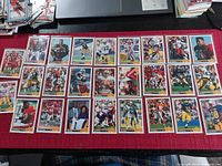Photo showing 26 Star brand rookie football cards laid out in rows, featuring various players in action and portrait shots with red card borders.