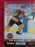 Close-up of the Ray Bourque hockey card from the Team Pinnacle series showing the player in a Bruins jersey on the ice, with branding and series details visible.