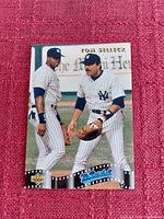 Photo of 1992 Upper Deck Mr. Baseball Tom Selleck trading card showing Tom Selleck and a player in New York Yankees uniforms on field.