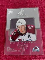 Photo of 2021-22 Upper Deck Honor Roll Nathan MacKinnon hockey card in plastic sleeve showing player image and card details.