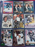 Photo showing 9 hockey cards featuring Wayne Gretzky and Gordie Howe including Upper Deck and Pinnacle cards in plastic sleeve laid out in 3x3 grid.