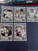 Six Wayne Gretzky Hockey Heroes Upper Deck cards in plastic sleeve, each card showing a distinct image and text regarding his career and achievements.
