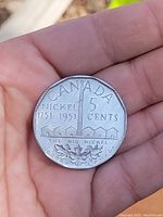 Reverse side showing the denomination, "The Big Nickel" inscription and design.