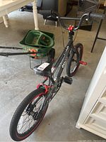 Full view of black and red boys bike with 18-inch wheels showing overall condition and features including frame, handlebars, seat, and pedals.