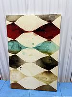 Full front view of the abstract canvas print showing the multi-colored repeating organic shapes in rows with visible stains and marks.