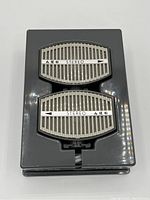 Front view showing the two AKG stereo microphone capsules inside gray molded plastic case.