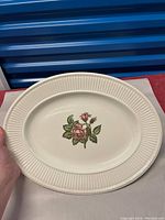 Full view of the white Wedgwood platter with ribbed edges and central floral design.