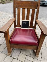 Front view showing slat back, arms, seat cushion