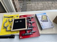 Photo showing the unopened 10-piece Husky T-handle wrench set, 8-outlet Mastercraft power bar in box, and unused Everbilt hooks in yellow packaging