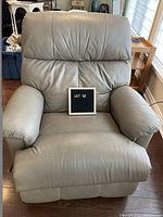 Front view of taupe leather recliner showing backrest, seat and armrests