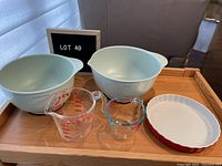 KitchenAid mixing bowls (4.5 and 3.5 quarts) with two glass measuring cups and red flan pan arranged on wooden tray