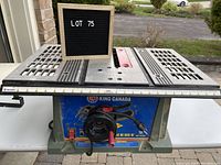 Full view of King Canada table saw on table with LOT 75 sign in front.