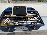 Photo showing the toolbox filled with assorted ratchets, sockets, combination wrenches and tools